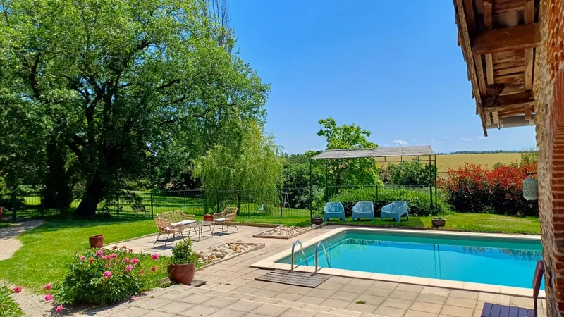 Piscine de La Balagane avec clôture et vue sur le domaine tarnais en été