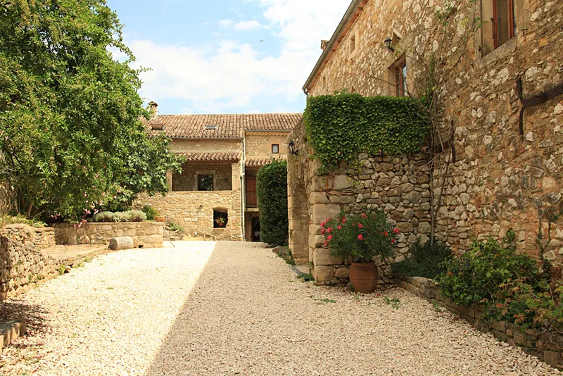 Cour intérieure du mas ardéchois avec ses bâtisses en pierre
