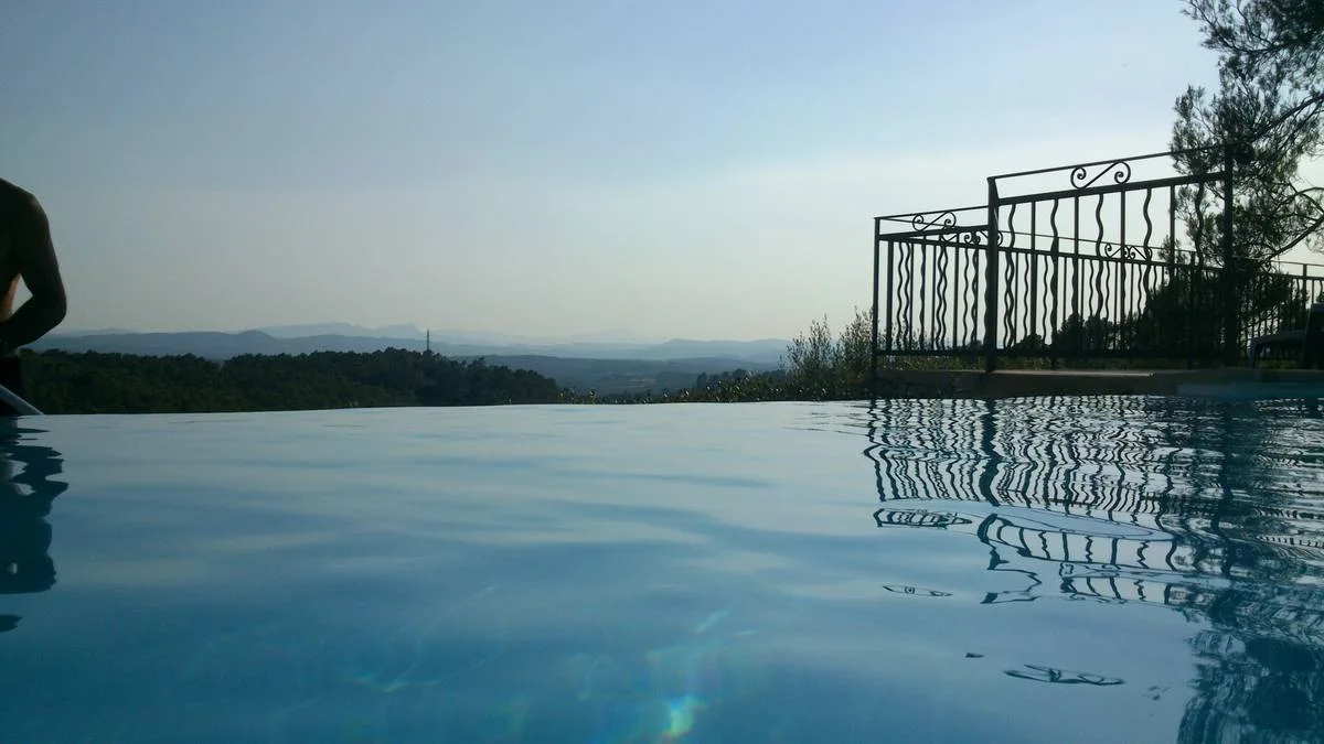 Gîte de groupe Les Bastides Provençales à Entrecasteaux — Piscine à débordement au coucher du soleil avec vue panoramique sur vallée provençale, capacité 41 personnes