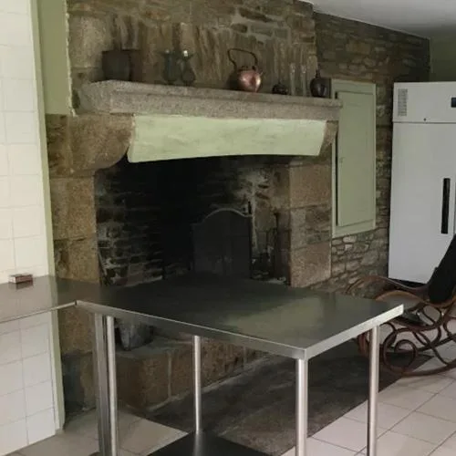 Cuisine équipée avec cheminée en pierre dans le gîte Le Couesnon