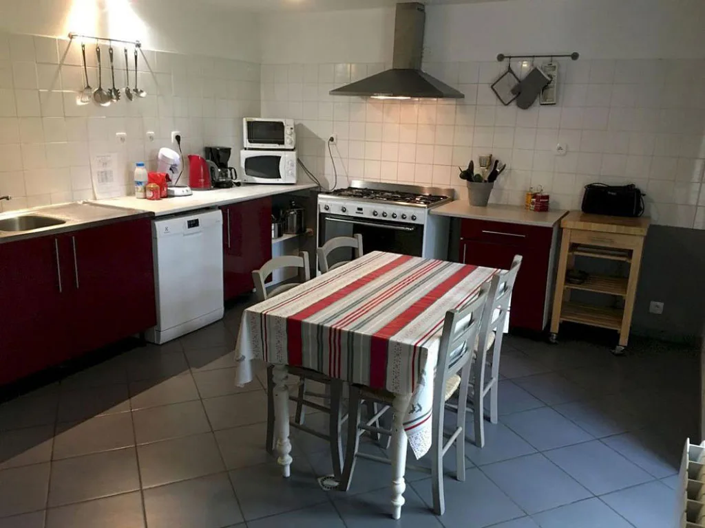 Cuisine équipée avec table à rayures et chaises pour les repas de groupe