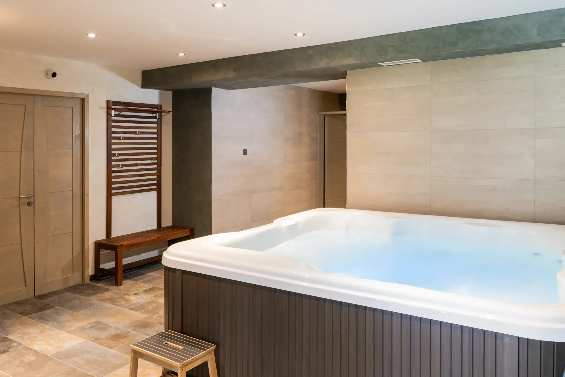 Spa jacuzzi extérieur en bois avec vue sur les arbres environnants