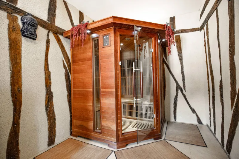 Sauna en bois avec banquettes, équipement bien-être du domaine