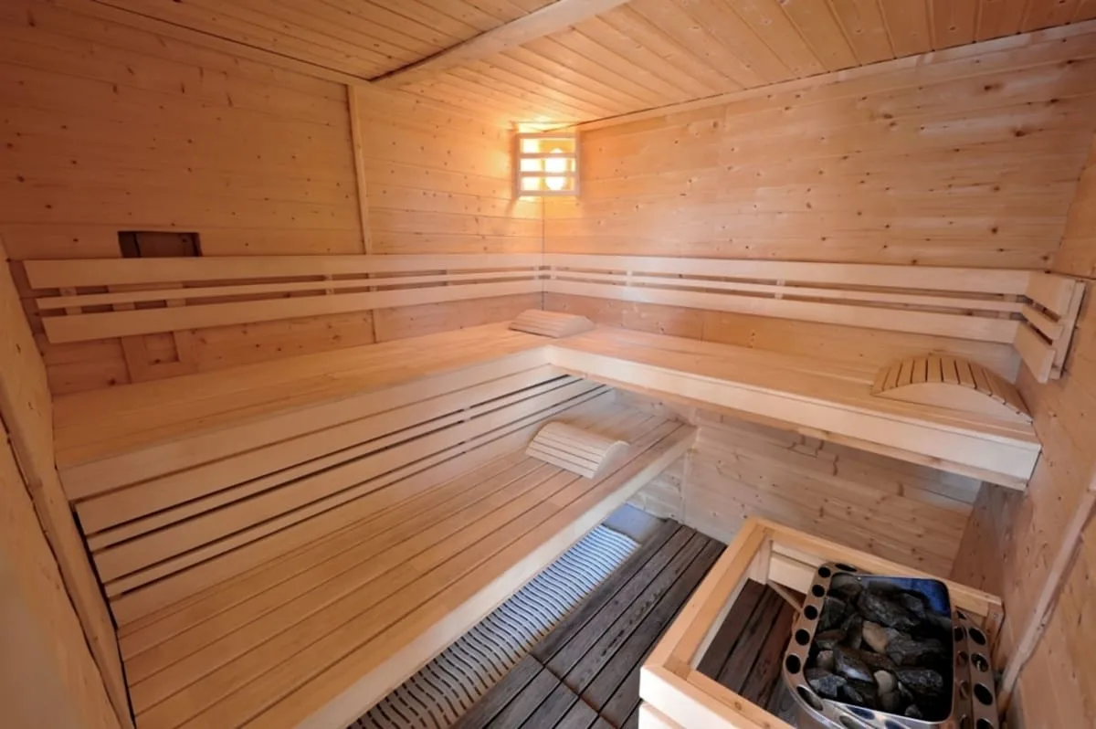Intérieur du sauna en bois avec bancs et poêle de chauffage