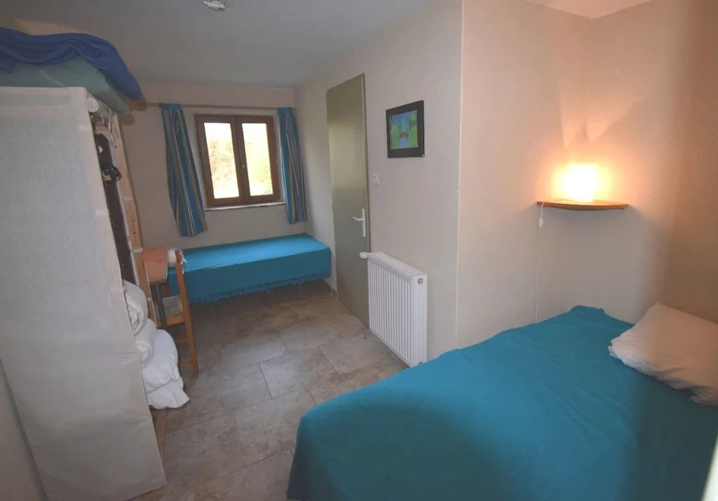 Chambre aux tons bleus avec lits doubles et literie soignée
