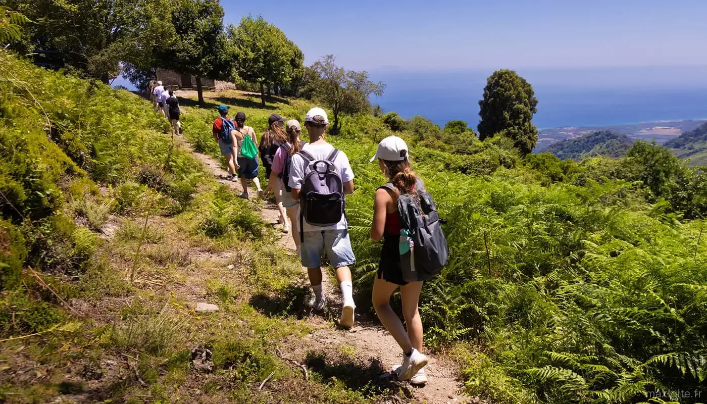 Groupe en randonnée sur un sentier surplombant la mer Méditerranée